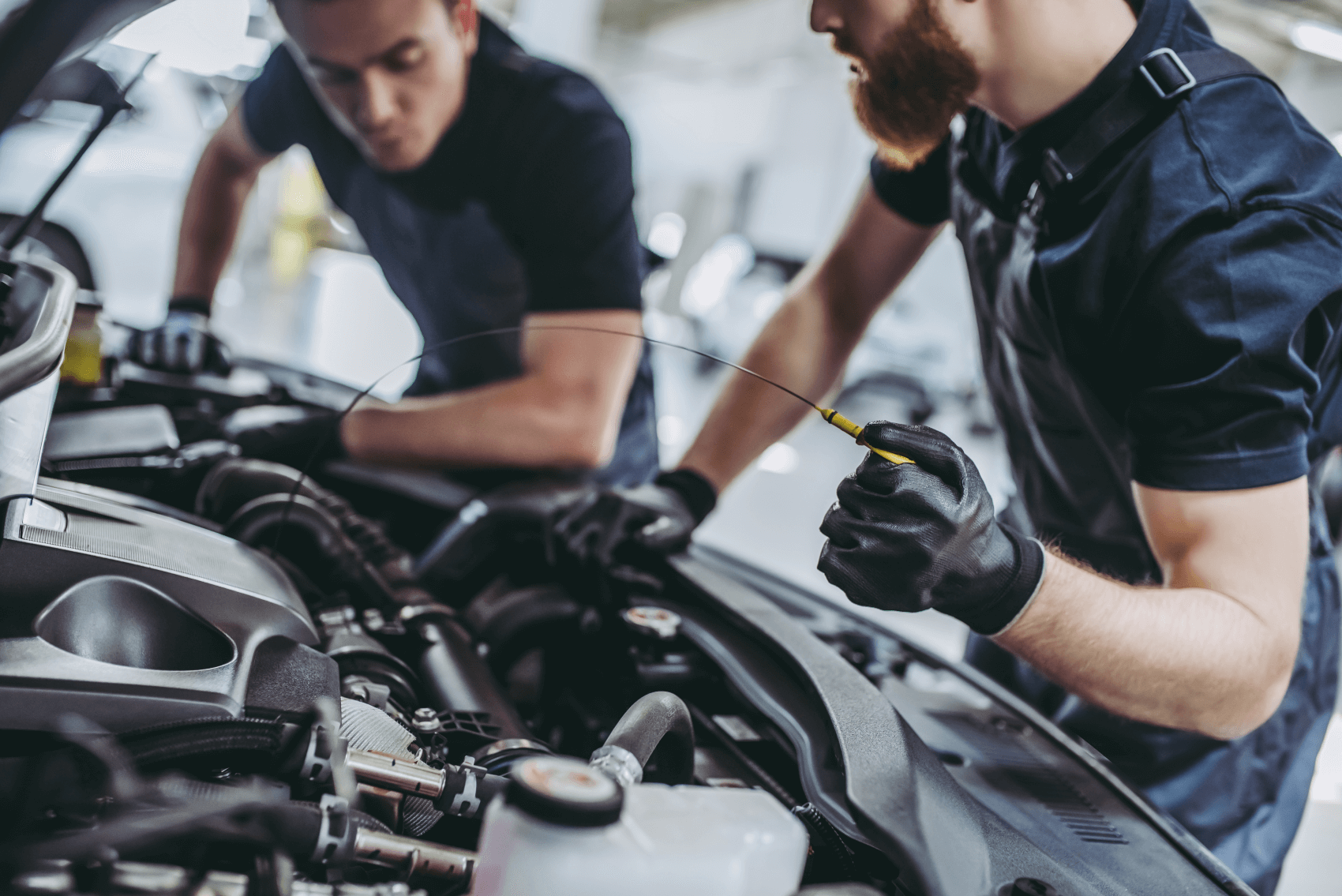 Volkswagen Service Technicians Completing an Oil Change